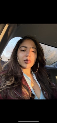 a woman is taking a selfie in the back seat of a car